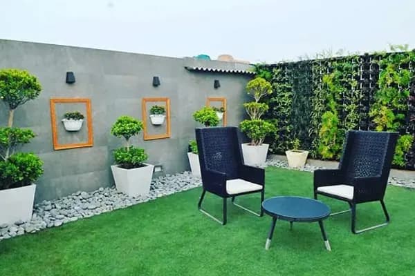 Terrace garden with seating, planters and a green wall